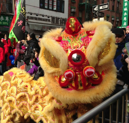 A lion dance costume is being worn by people.