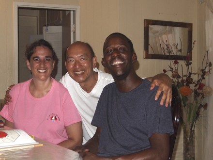 Three people sitting at a table smiling for the camera.