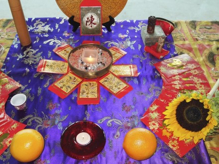 A table with oranges and candles on it.